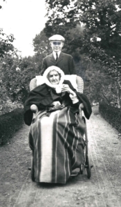 Armistead Peter 3rd pushing Great Grandmother Britannia Wellington Peter Kennon in wheelchair c.1910. C34