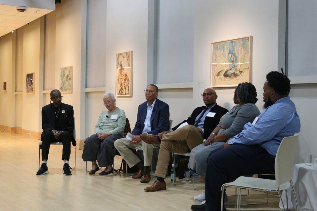 Group of descendants sitting in semi circle with Fred Murphy, facilitator in center