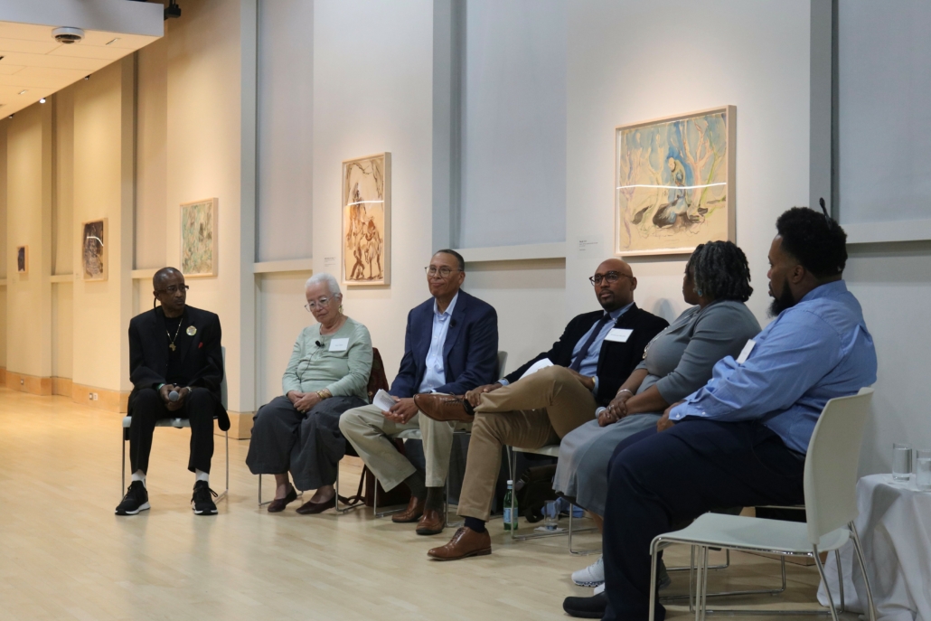 Descendants sitting in a semi-circle with Fred Murphy, facilitator, sitting in middle at gallery space at Georgetown University.