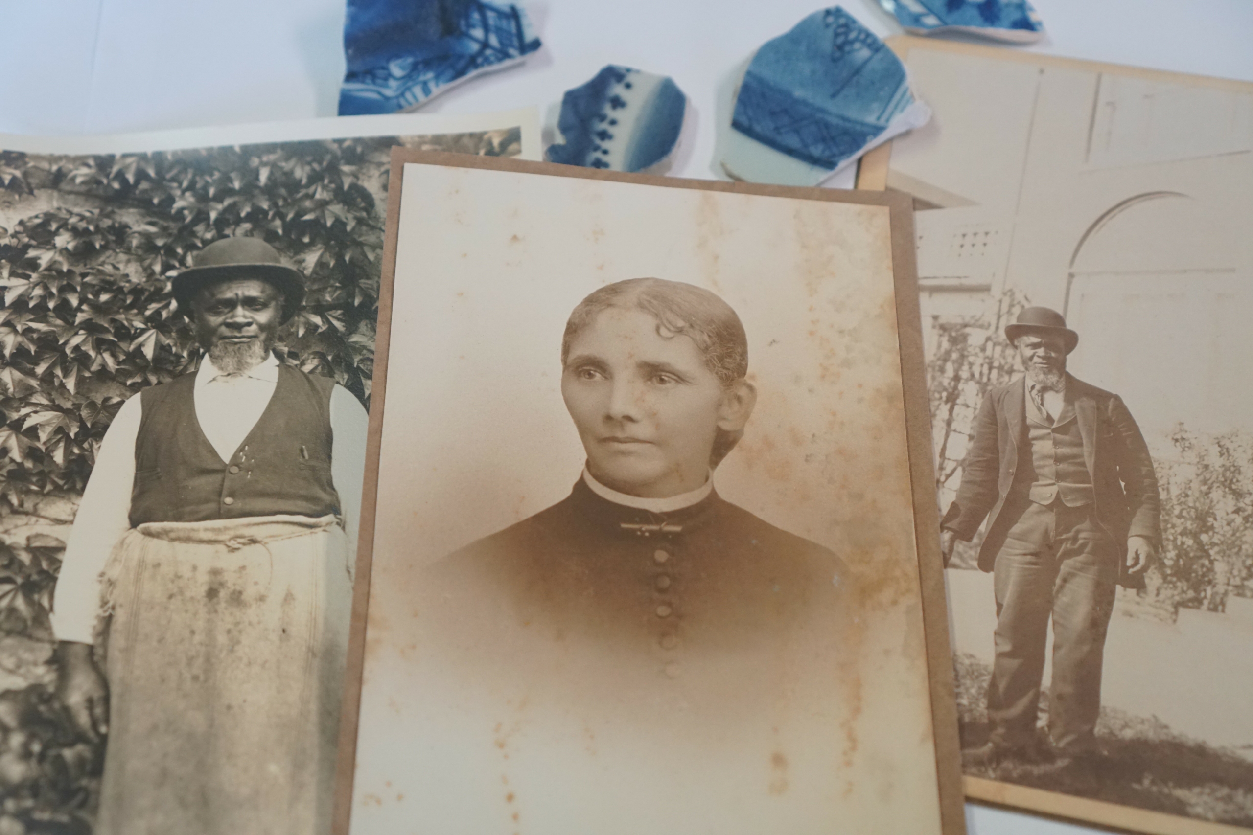 Collage of old photos stacked on top of each other with portrait of Hannah Pope on top.