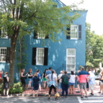 Civil War Washington Teachers surround the blue house in Georgetown