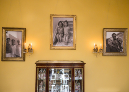 3 Portraits hanging on a yellow painged wall