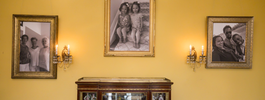 3 Portraits hanging on a yellow painged wall