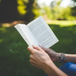 woman's hands holding book