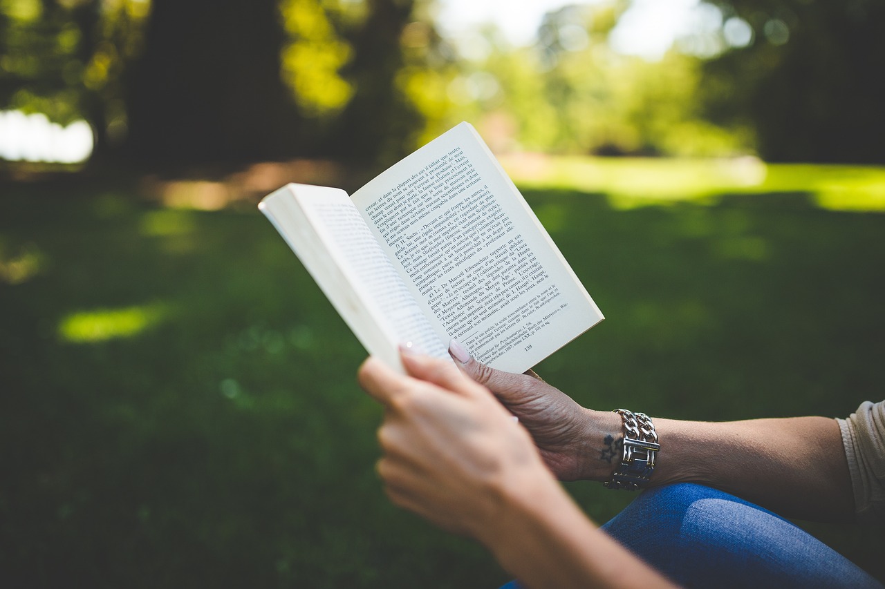 woman's hands holding book